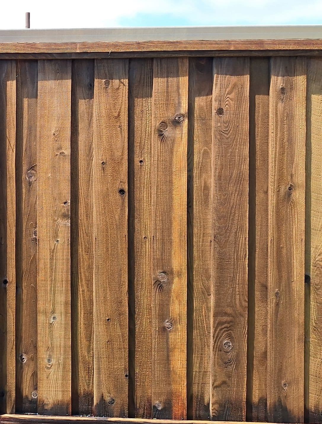 A fence in Santa Cruz, CA after pressure washing